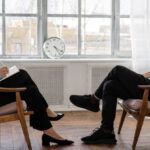 Analytics Features - Person in Black Pants and Black Shoes Sitting on Brown Wooden Chair