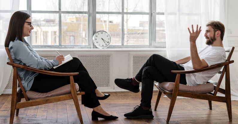 Analytics Features - Person in Black Pants and Black Shoes Sitting on Brown Wooden Chair