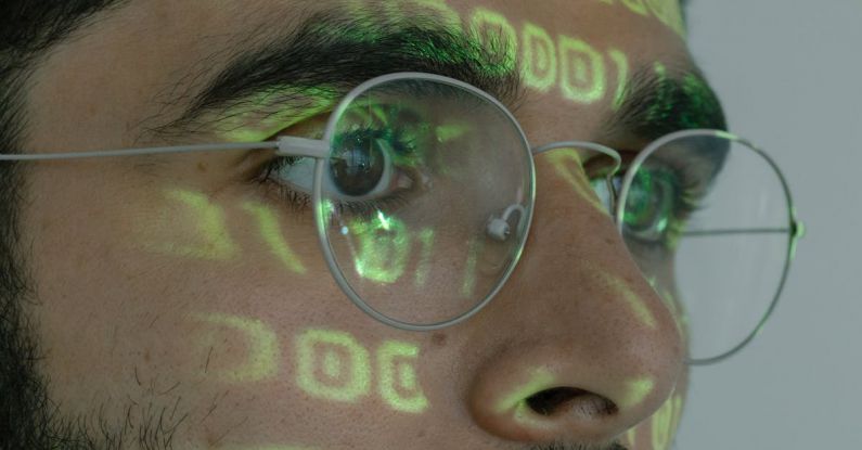 Digital Identity Theft - Man With Binary Code Projected on His Face
