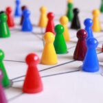 Tactics - Close Up Photography of Yellow Green Red and Brown Plastic Cones on White Lined Surface