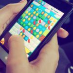 Mobile Games - Person Playing Candy Crush on Nokia Smartphone