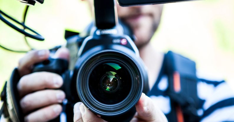 Viral Videos - Person Holding Canon Dslr Camera Close-up Photo