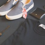 Brands - Pair of Gray Vans Low-top Sneakers Beside Black Shirt, Sunglasses, and Watch