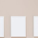 Ad Campaigns - Empty white photo frames hanging on gray wall