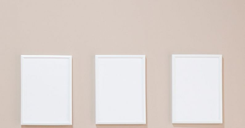 Ad Campaigns - Empty white photo frames hanging on gray wall