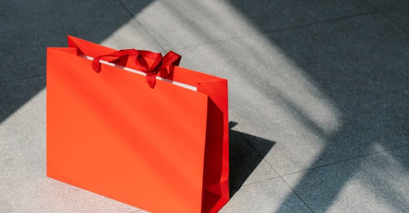 Ad Campaigns - Red paper shopping bag on gray ground